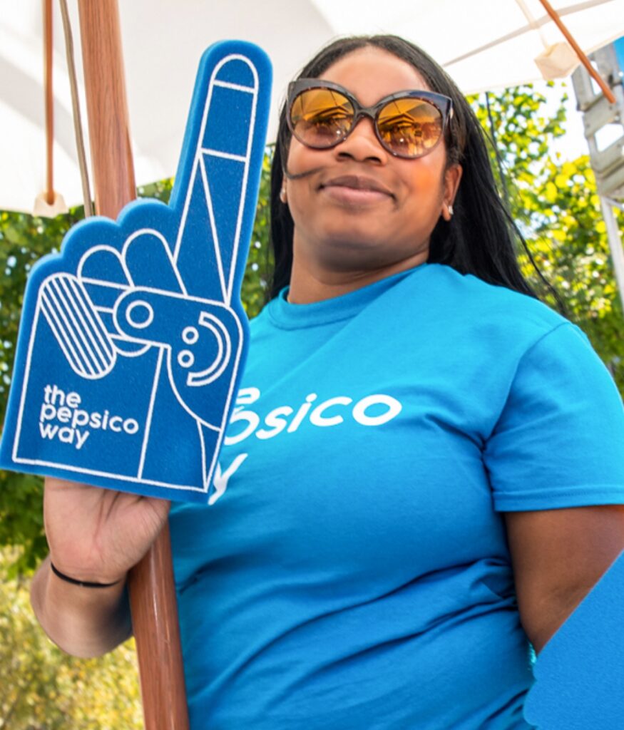 Woman wearing sunglasses and holding blue foam finger